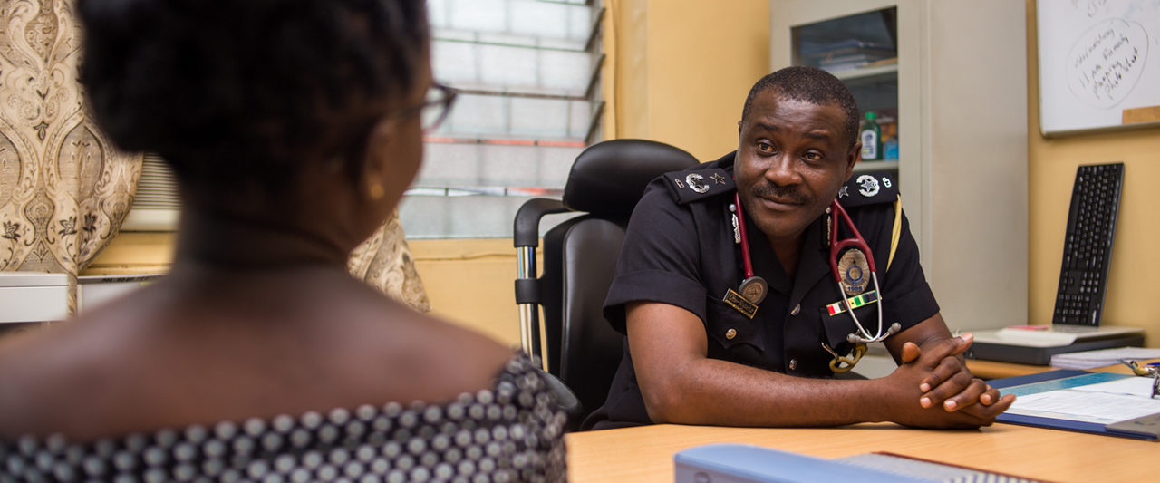 Dr. Samuel Otu-Nyarko counsels a young woman at the Ghana police hospital.