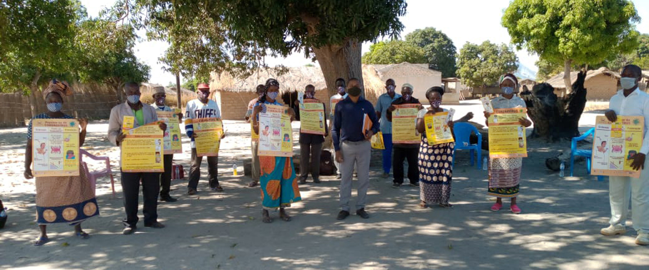 Participants hold up coronavirus protocol signs