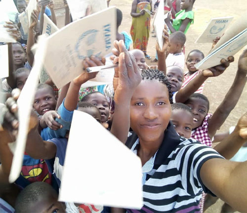 Tisungage Sitima with a group of children