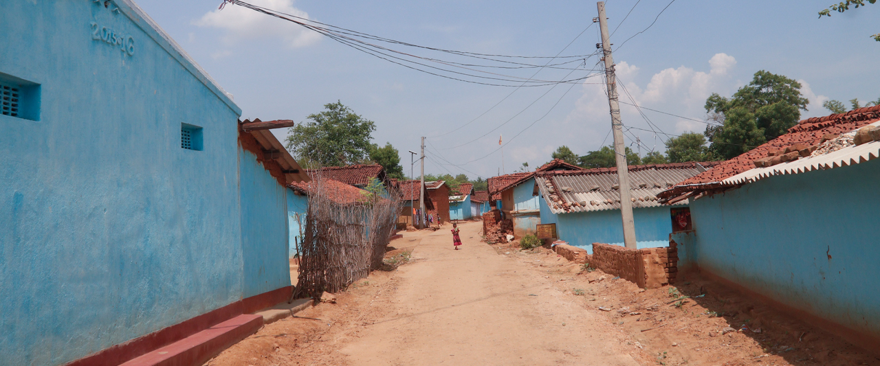 A young girl walks down the mud road on a sultry afternoon in the village of Indkata, India.