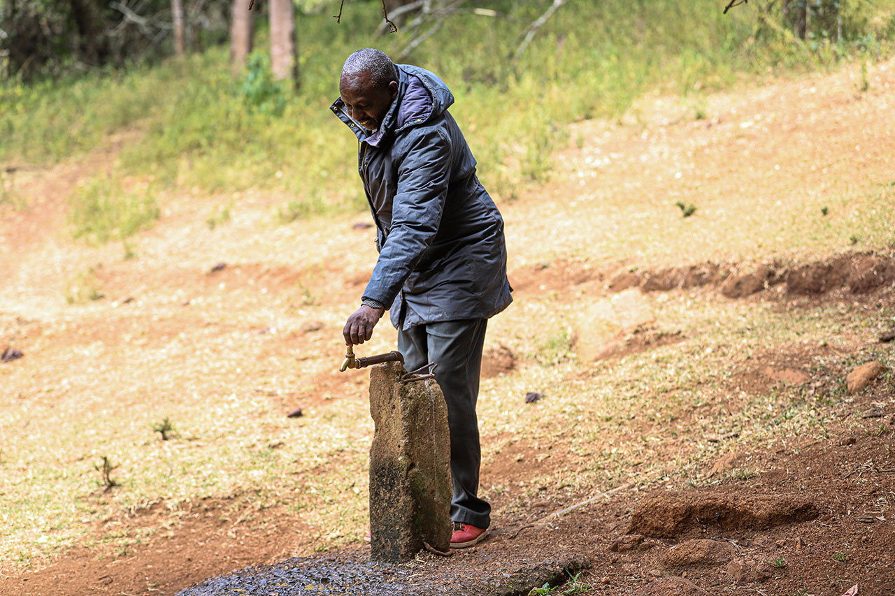 Phillip Simpano, Entasekera area Chief shows the community tap that was installed as part of the water project.