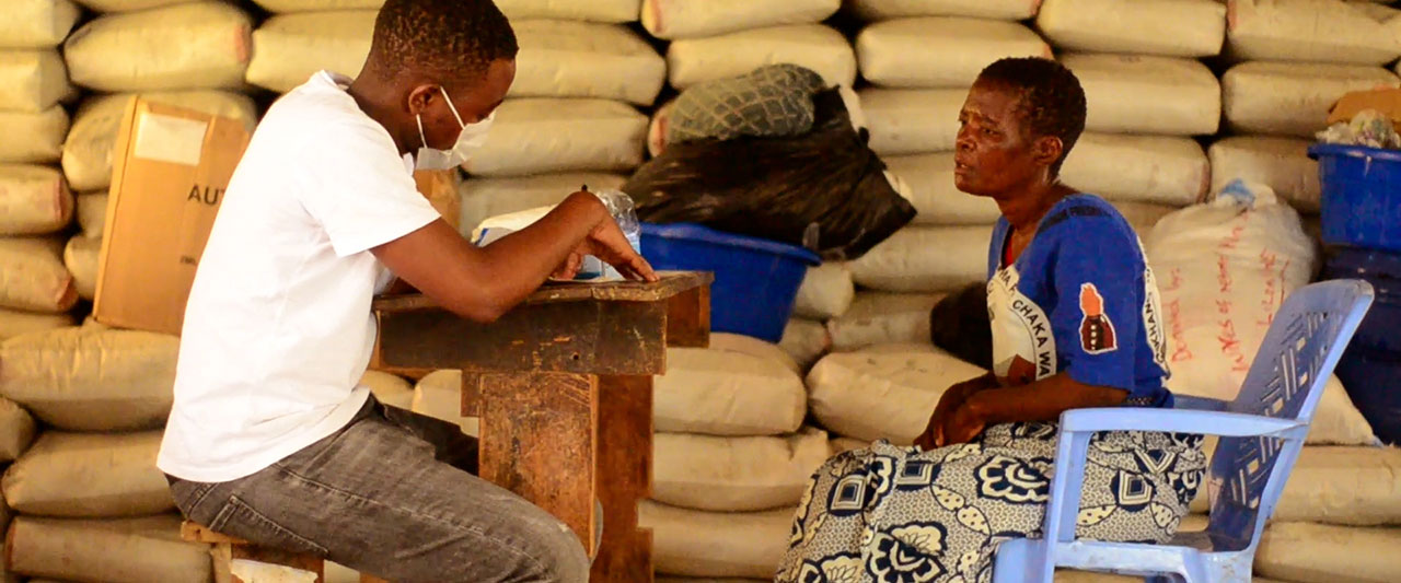 Health worker giving aid supplies to a woman