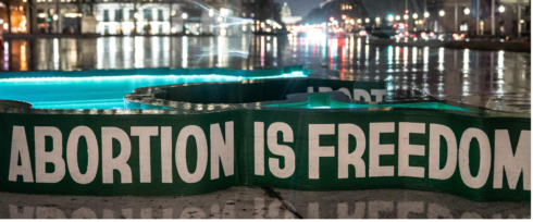 A reflective urban night scene showcases the words 